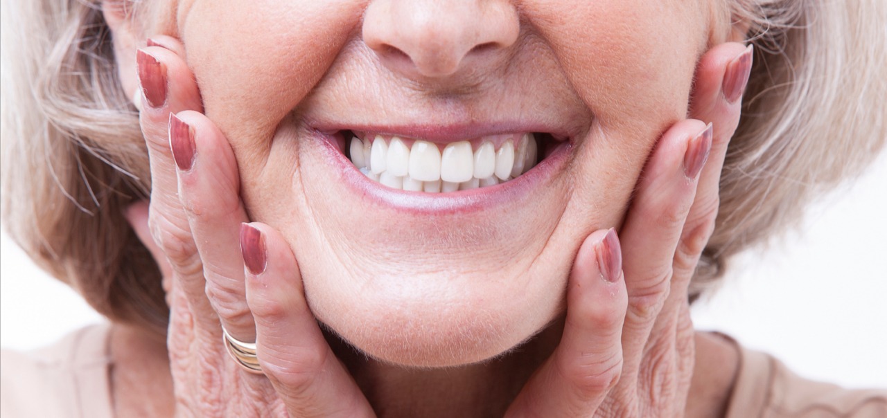 Woman smiling with dentures Woman smiling with dentures