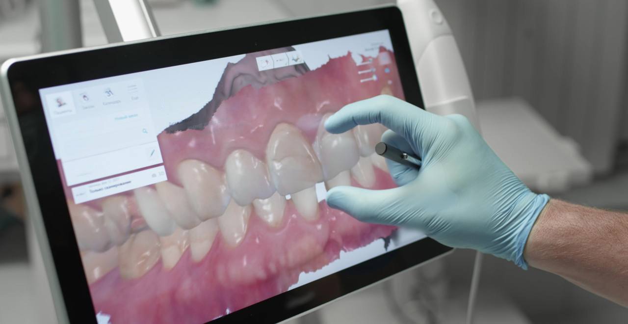 Dentist using digital technology on large screen