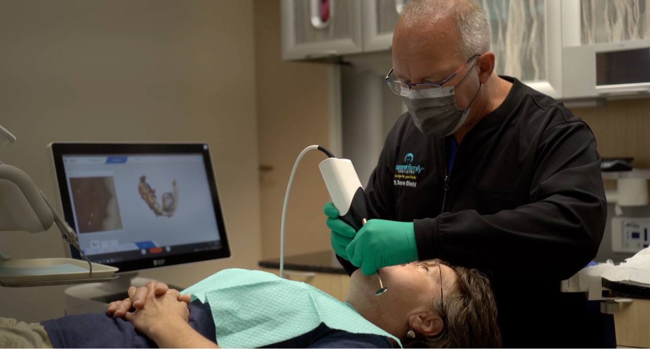 Dr. Diehl assessing patient's teeth